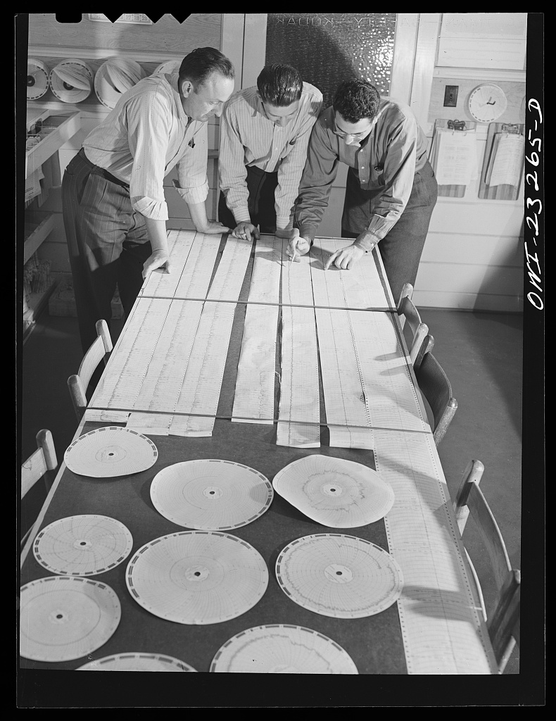 Worker consulting operations charts at the Southland paper mill in Lufkin, Texas, April 1943, photographed by John Vachon