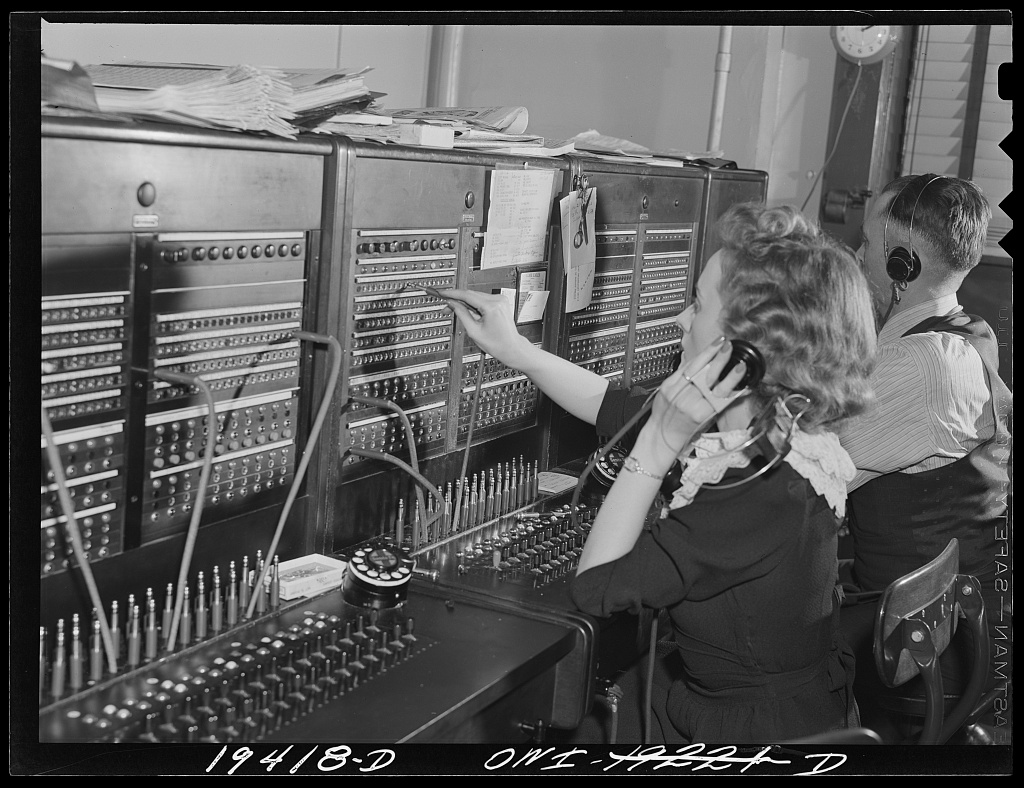 A private branch exchange operator at her switchboard in a railroad freight depot in Kansas City, Missouri, photographed by Jack Delano in March 1943